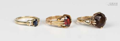 A 9ct gold ring, claw set with an oval cut garnet, Birmingha...