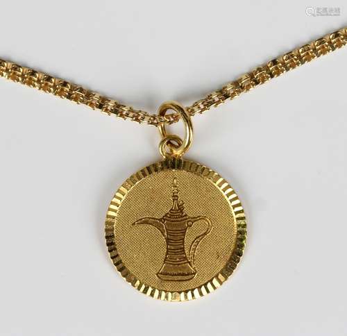 A gold circular pendant with a coffee pot motif, the suspens...