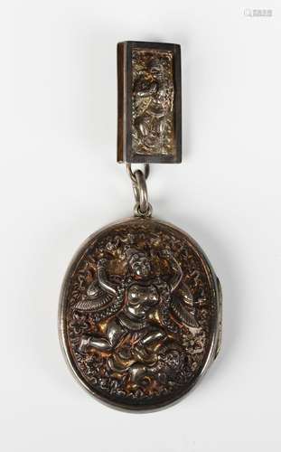 A late 19th century Burmese silver oval pendant locket, the ...