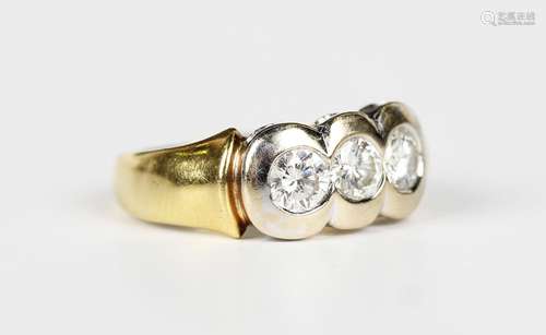 An 18ct two colour gold and diamond ring, mounted with a row...