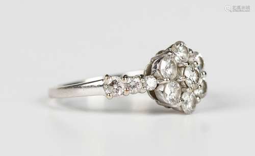 A white gold and diamond cluster ring in a flowerhead shaped...