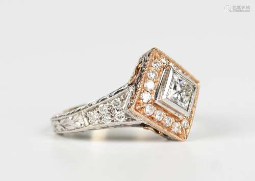 A two colour gold and diamond ring, mounted with the princip...