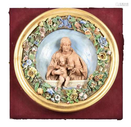 AN ITALIAN GLAZED AND BISCUIT POTTERY RELIEF MOULDED ROUNDEL...