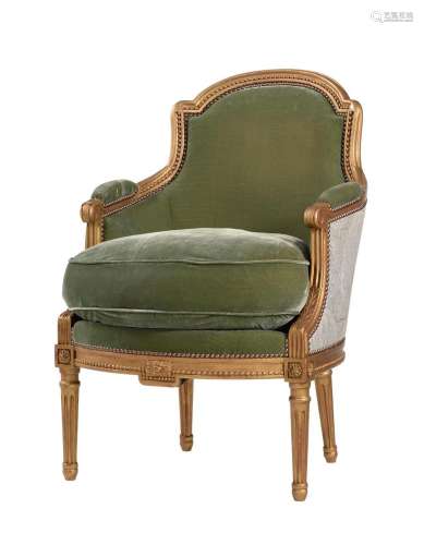 A FRENCH GILTWOOD AND UPHOLSTERED BERGÈRE ARMCHAIR