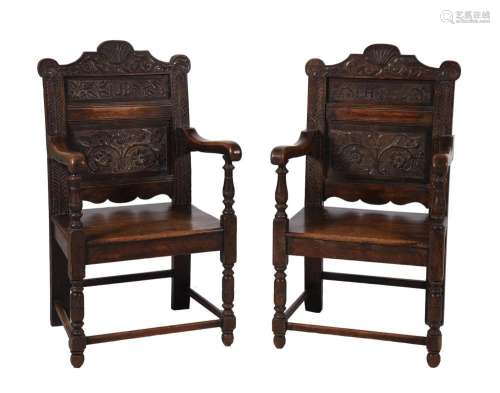 A NEAR PAIR OF OAK PANEL BACK ARMCHAIRS IN 17TH CENTURY STYL...