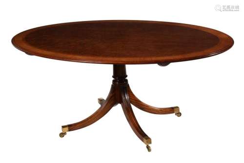 AN OVAL MAHOGANY CENTRE TABLE IN REGENCY STYLE