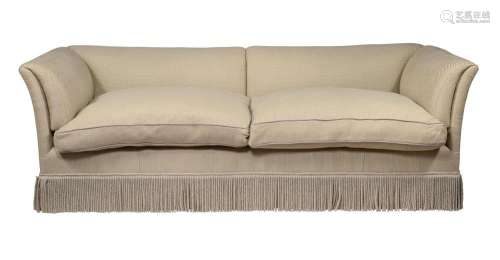 A LARGE MAHOGANY AND UPHOLSTERED SOFA IN THE MANNER OF HOWAR...