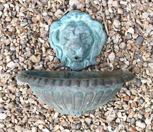 A VERDIGRIS PATINATED BRONZE LION MASK WALL FOUNT