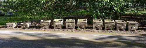 A SET OF EIGHT COMPOSITION STONE GARDEN PLANTERS