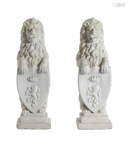 A PAIR OF WHITE PAINTED COMPOSITE STONE MODELS OF HERALDIC L...