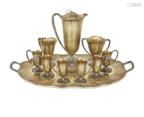 AN ART NOUVEAU SILVER-COLOURED-METAL WITH GILT FINISH COFFEE...