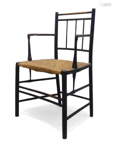 AN EBONISED BEECH AND RUSH SEATED CHAIR, IN THE MANNER OF MO...