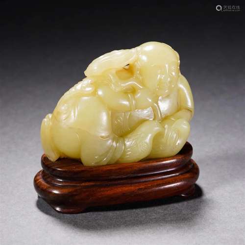 A Chinese Carved Yellow Jade Kid