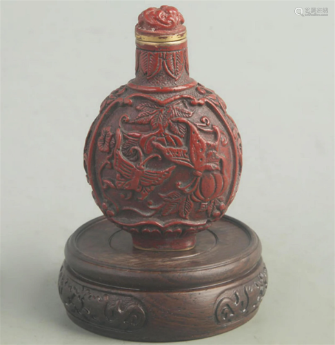 A FINE RED CARVED LACQUER BUTTERFLY CARVING SNUFF BOTTLE