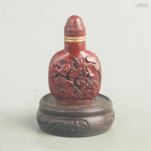 A FINE RED CARVED LACQUER LOTUS CARVING SNUFF BOTTLE