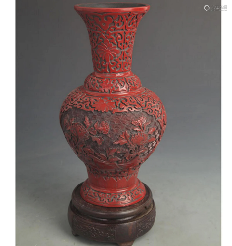 A FINE RED CARVED LACQUER FLOWER PATTERN VASE