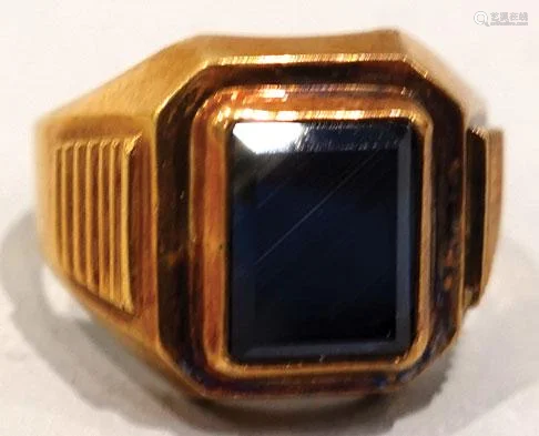 A gold ring with black sapphire