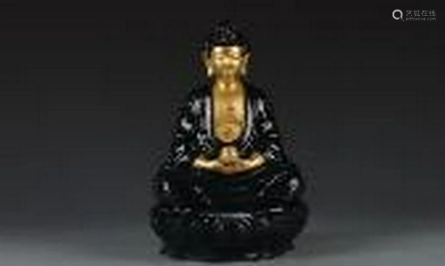 Gold buddha with black glazing clothes