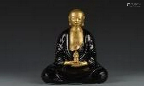 Gold buddha with black glazing clothes