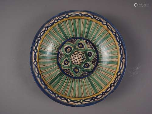 A 19th century Moorish shallow bowl with green, yellow and b...