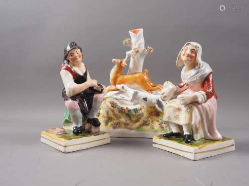 A pair of Staffordshire figures, cobbler and his wife, on sq...