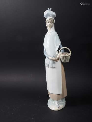 A Lladro figure of a girl with a basket of fruit, 14 high, a...
