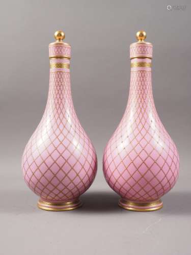 A pair of Sevres style porcelain bottle vases and covers wit...