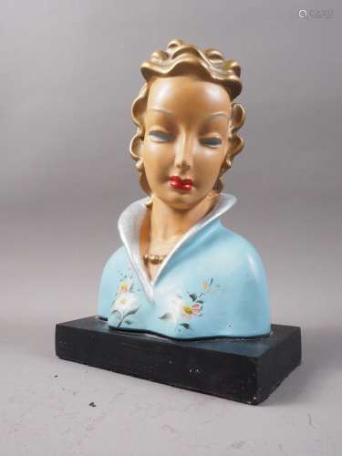 A Lenci style Art Deco bust of a woman in floral coat, on bl...
