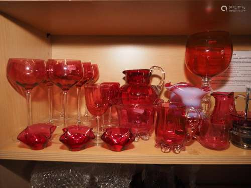 A collection of cranberry glass, including six wines, a pair...