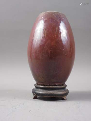 A Chinese flambe glazed barrel-shaped vase, 6 1/2 high, on t...