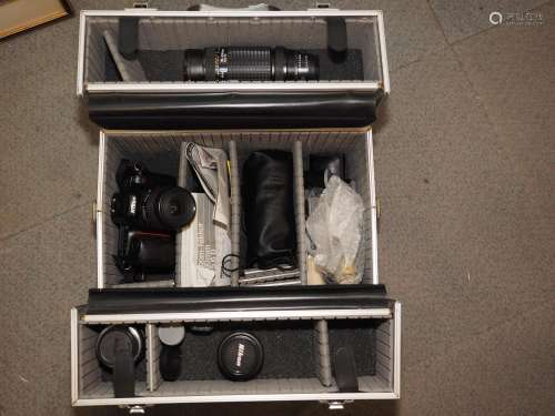 A Nikon F5 camera and a number of additional lenses and acce...