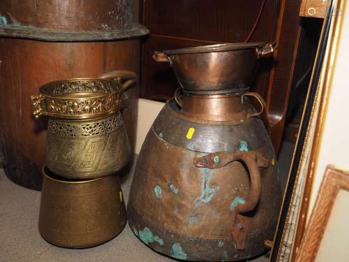 A Middle Eastern copper and brass two-handled pot, a smaller...