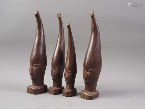 A set of four mid 20th century carved wenge Benin heads, tal...