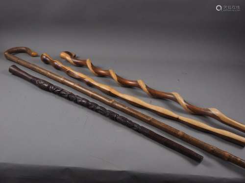A twisted hardwood walking stick, a similar walking stick, a...