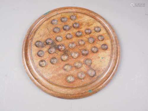 A 19th century turned walnut solitaire board, 14 dia