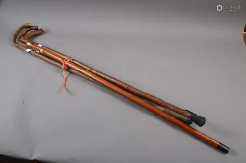 A Malacca cane with gilt metal mounts, a bamboo and white me...