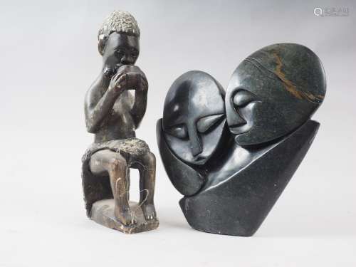 An African carved green stone double head group, by Tapina J...