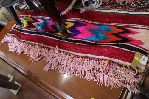 A Mexican hand-woven throw, decorated bands of vibrant colou...
