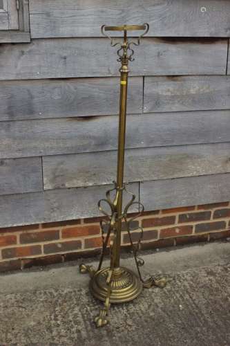 An early 20th century brass scrollwork standard lamp with re...