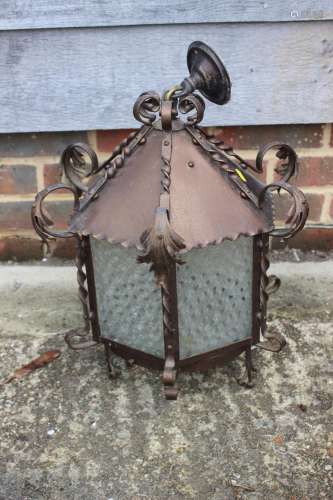 A wrought iron hexagonal ceiling lantern with acanthus leaf ...