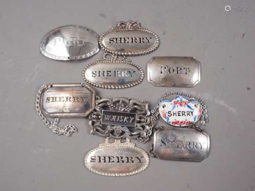 Eight assorted silver plated bottle tickets/decanter labels ...
