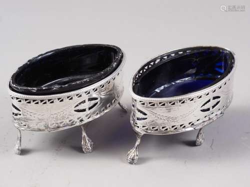 A pair of Georgian silver oval salts with pierced and engrav...