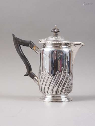 A silver hot water jug with half spiral fluted decoration an...