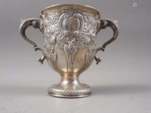 A Georgian silver two-handled pedestal cup with later emboss...