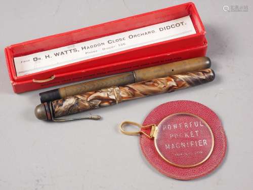 Two early 20th century fountain pens and a pocket magnifier,...