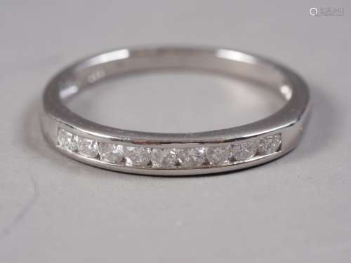 A white metal and diamond half eternity ring, stamped Plat, ...