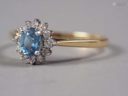 An 18ct gold aquamarine and diamond cluster ring, size P