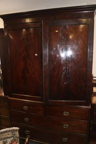 An early 19th century figured mahogany linen press, the uppe...