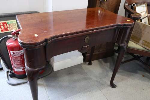 An early George III mahogany fold-over top card table with c...