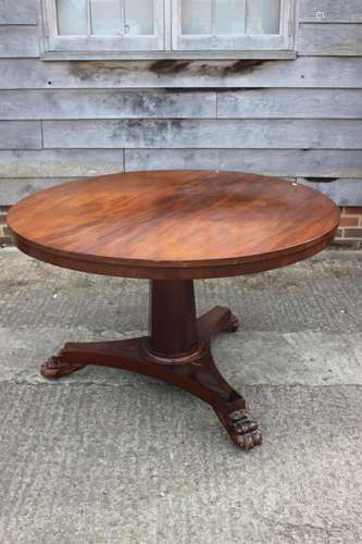 A 19th century mahogany circular dining table, on faceted co...